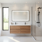 Modern bathroom with wooden vanity, mirror, and shower area.